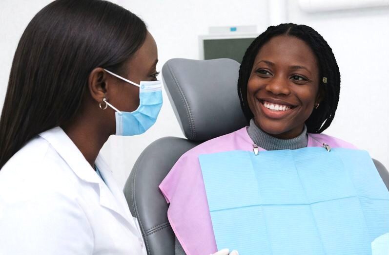 Dentist and happy patient at Warm Smile Dental after dental check-up